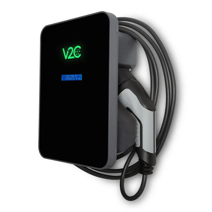 V2C Trydan 22kW Type 2 EV charger in black with V2C logo illuminated green showing active charging status, blue LCD and tethered cable